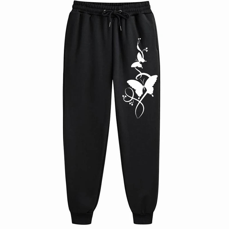 Black sweatpants with white floral design on a white background