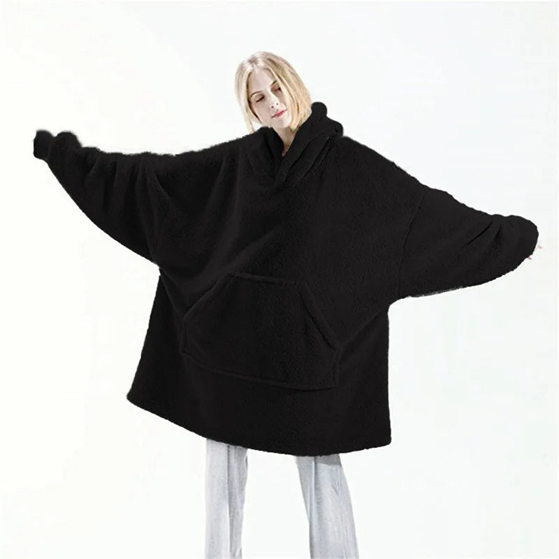 Black oversized hoodie worn by a person on a white background