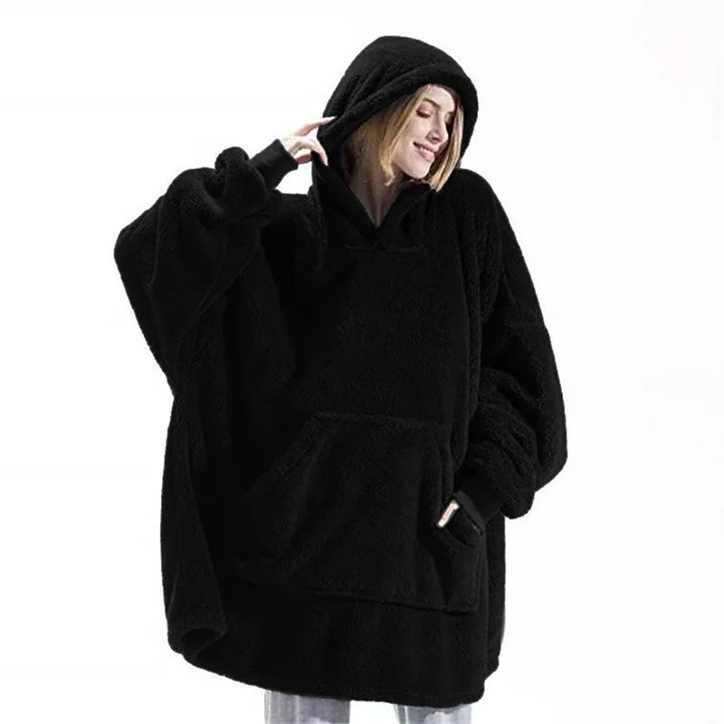 Person wearing a black oversized hoodie on a white background