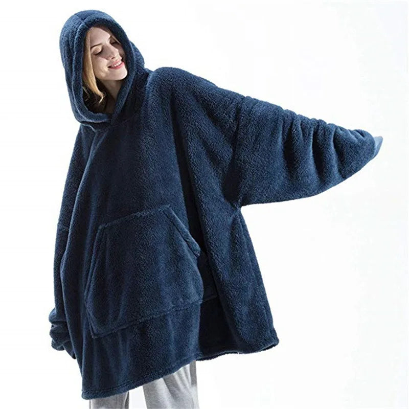 Person wearing a blue fleece poncho on a white background