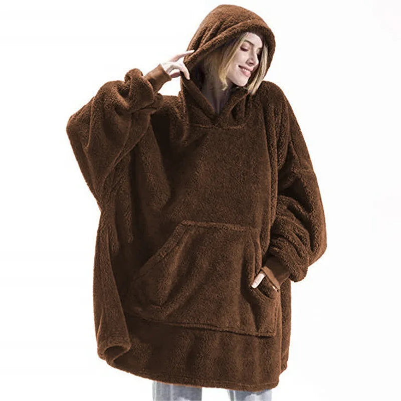 Person wearing a brown fleece poncho with a hood on a white background