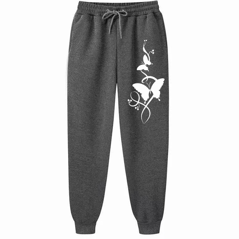 Dark gray sweatpants with a white butterfly design on a white background